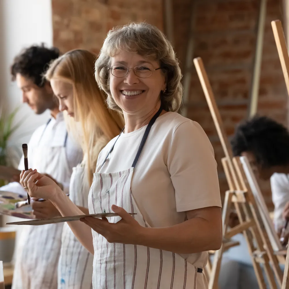 Patient enjoying a painting class, reflecting confidence in everyday life